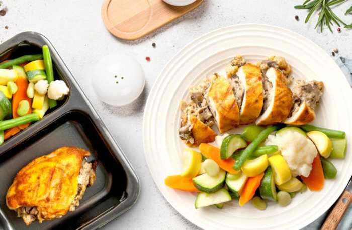 Plate of mushroom stuffed chicken and roasted vegetables